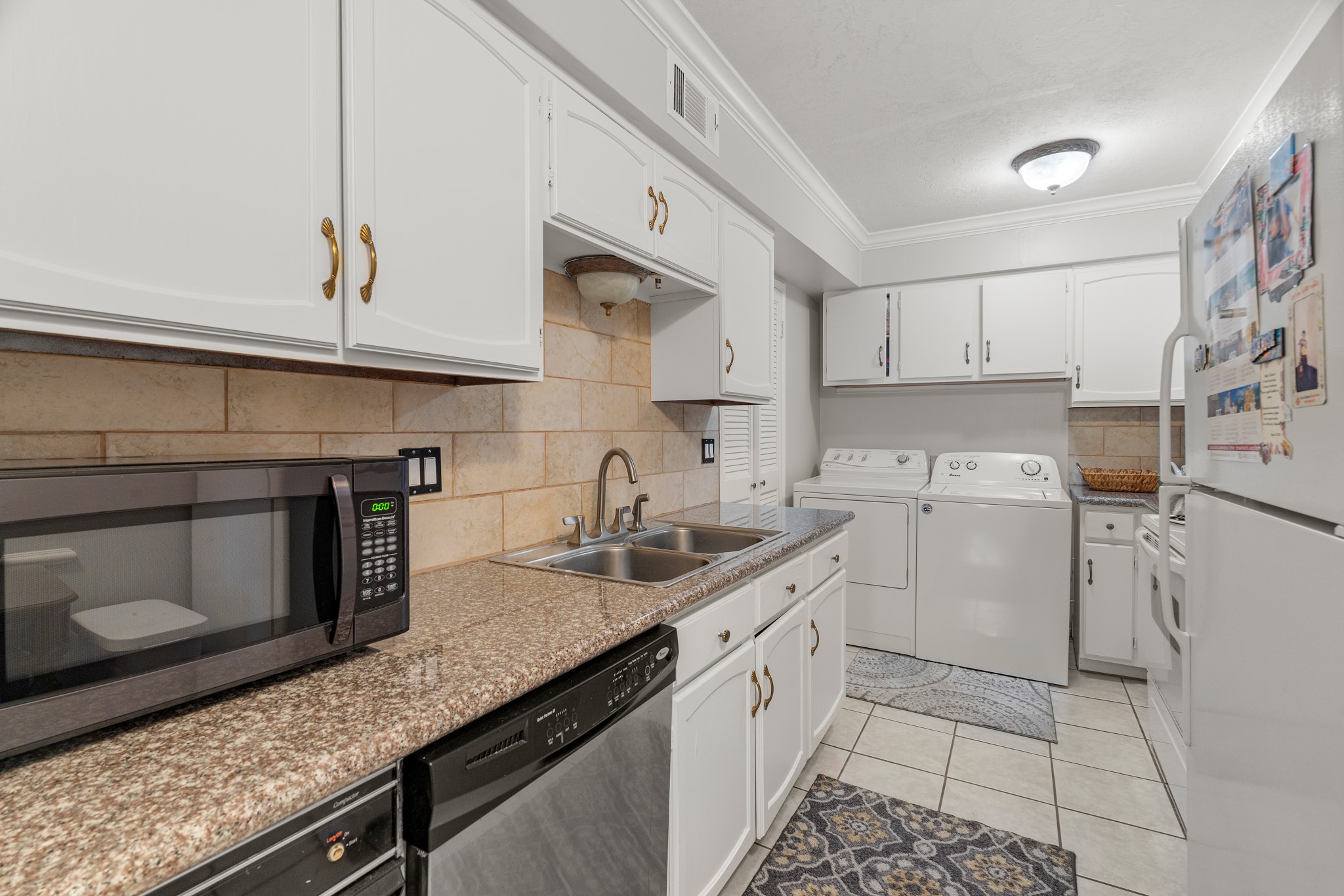 355 North Post Oak Lane, Unit 742 Houston, TX 77024 - Photo 15 of 18 a kitchen with a sink stove and cabinets