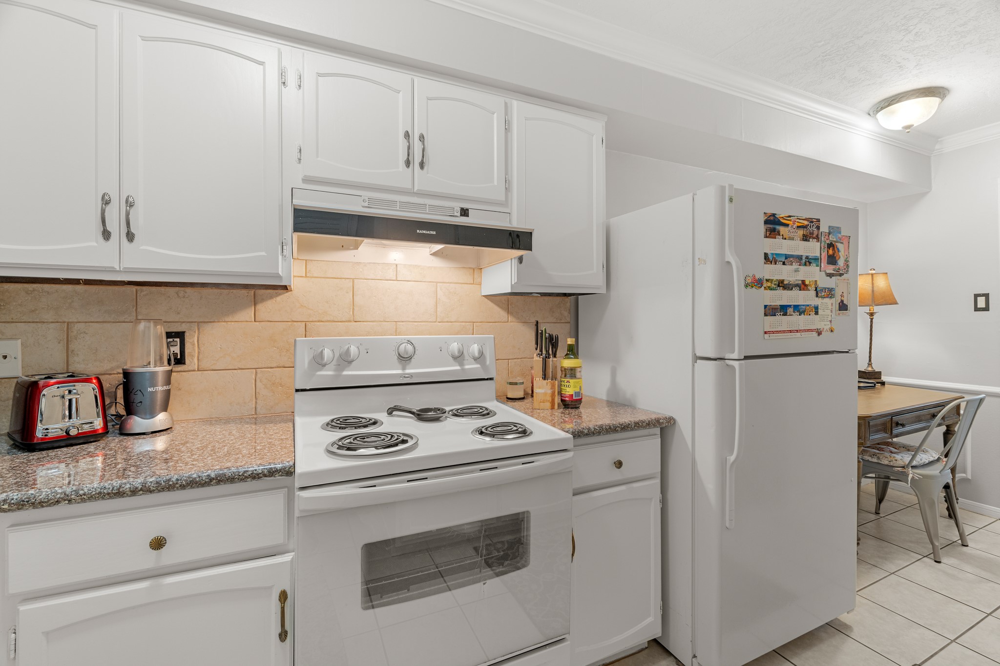 355 North Post Oak Lane, Unit 742 Houston, TX 77024 - Photo 16 of 18 a kitchen with refrigerator a stove a sink and cabinets