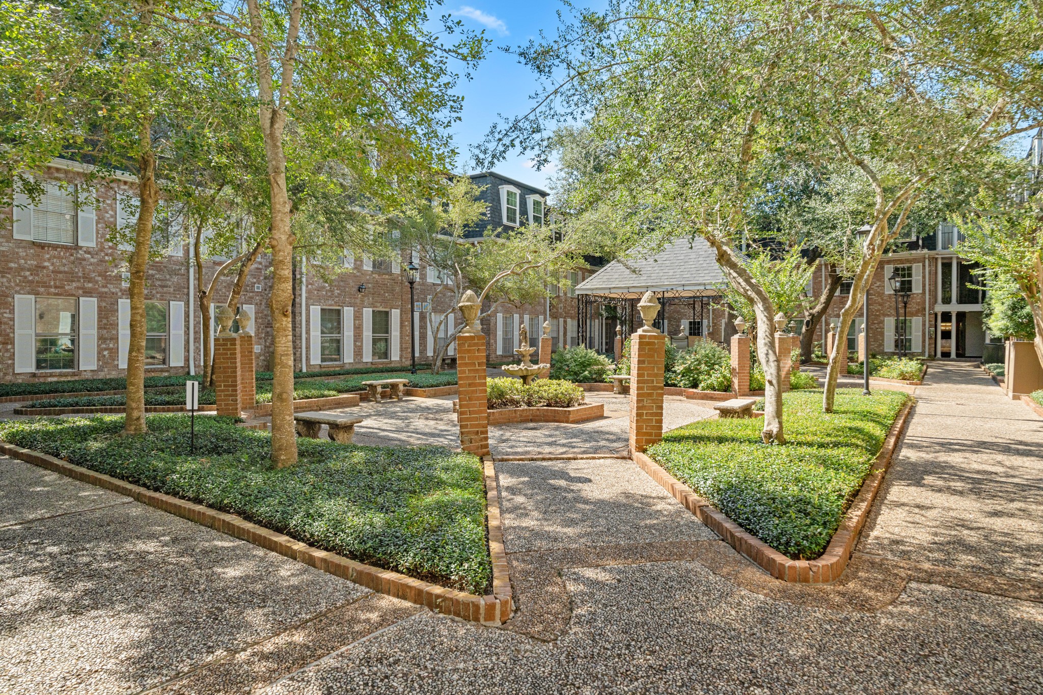 355 North Post Oak Lane, Unit 742 Houston, TX 77024 - Photo 17 of 18 a front view of a residential apartment building with a yard and green space