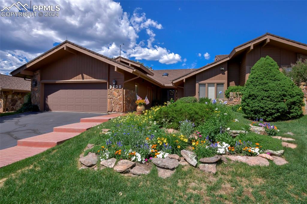 3130 Camels Ridge Lane Colorado Springs, CO 80904 - Photo 2 of 35 a front view of a house with a yard