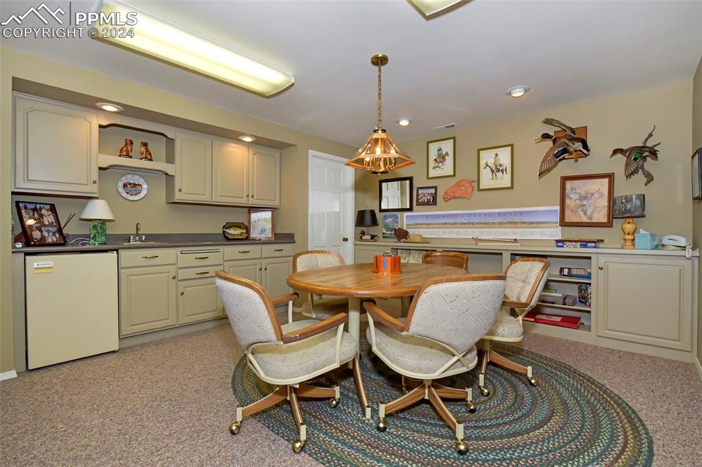 3130 Camels Ridge Lane Colorado Springs, CO 80904 - Photo 22 of 35 a dining room with a sink a counter and chairs