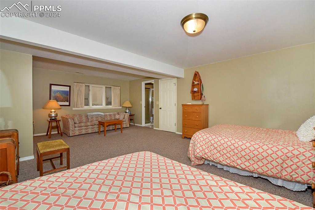 3130 Camels Ridge Lane Colorado Springs, CO 80904 - Photo 23 of 35 a bedroom with a bed and a lamp on dresser