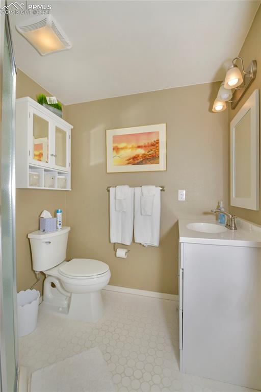 3130 Camels Ridge Lane Colorado Springs, CO 80904 - Photo 24 of 35 a bathroom with a toilet sink and mirror