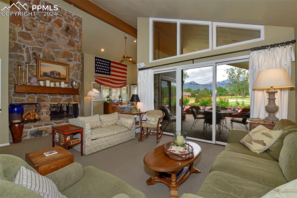 3130 Camels Ridge Lane Colorado Springs, CO 80904 - Photo 4 of 35 a living room with furniture a fireplace and a large window