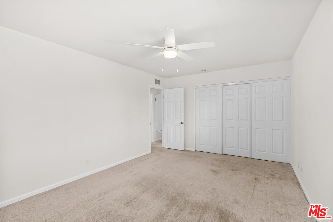 186 Southampton Way, Unit 29 Placentia, CA 92870 - Photo 11 of 20 an empty room with a ceiling fan and a window