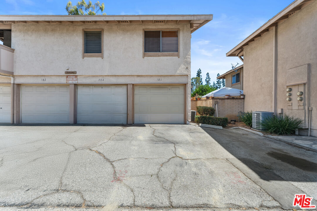186 Southampton Way, Unit 29 Placentia, CA 92870 - Photo 20 of 20 a front view of a house with a yard and garage
