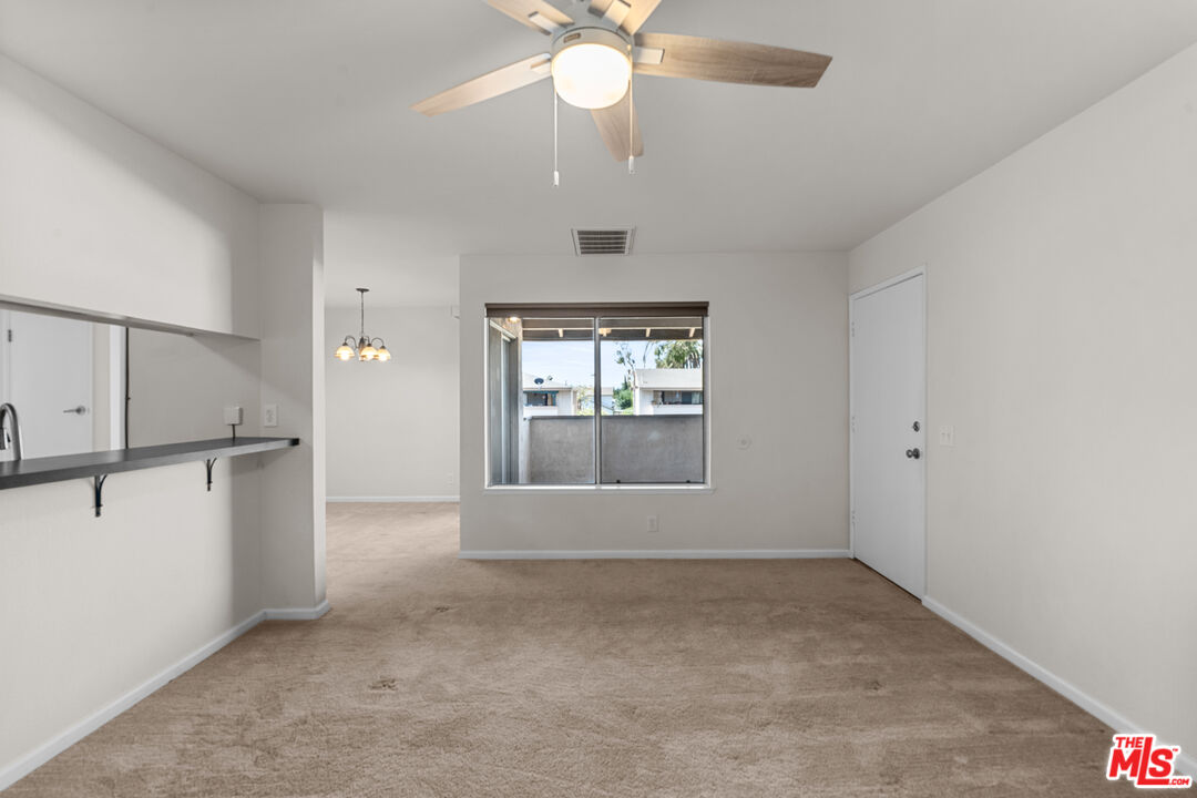 186 Southampton Way, Unit 29 Placentia, CA 92870 - Photo 4 of 20 an empty room with windows and ceiling fan