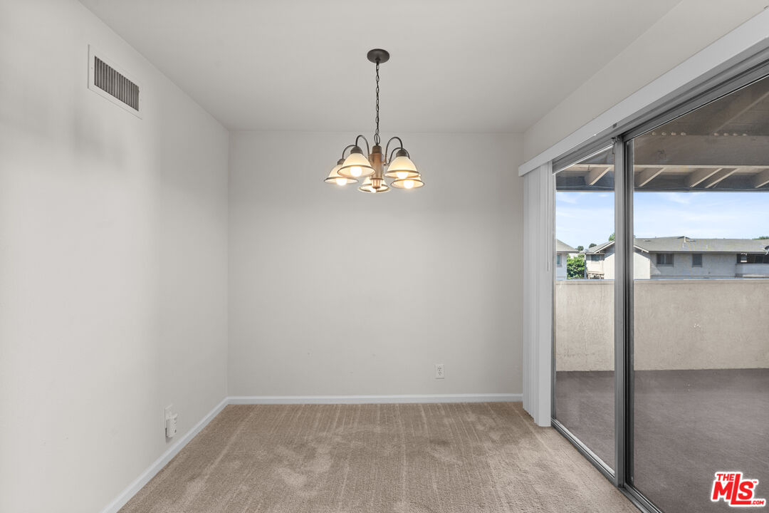 186 Southampton Way, Unit 29 Placentia, CA 92870 - Photo 7 of 20 a view of a chandelier fan and wooden floor