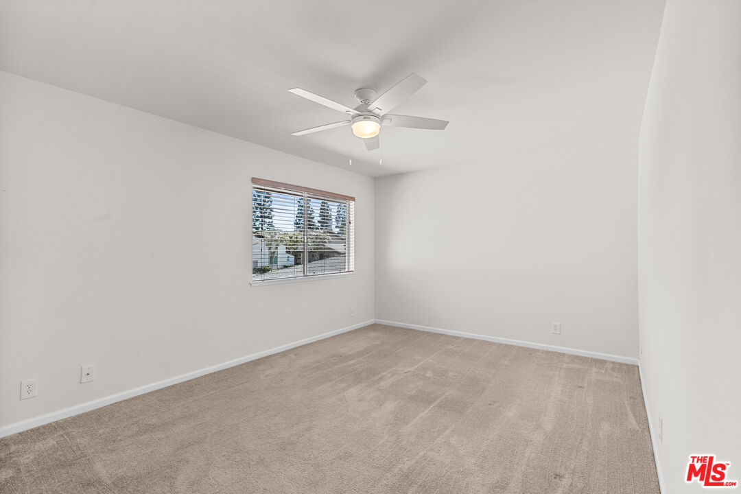 186 Southampton Way, Unit 29 Placentia, CA 92870 - Photo 10 of 20 an empty room with a window and a fan