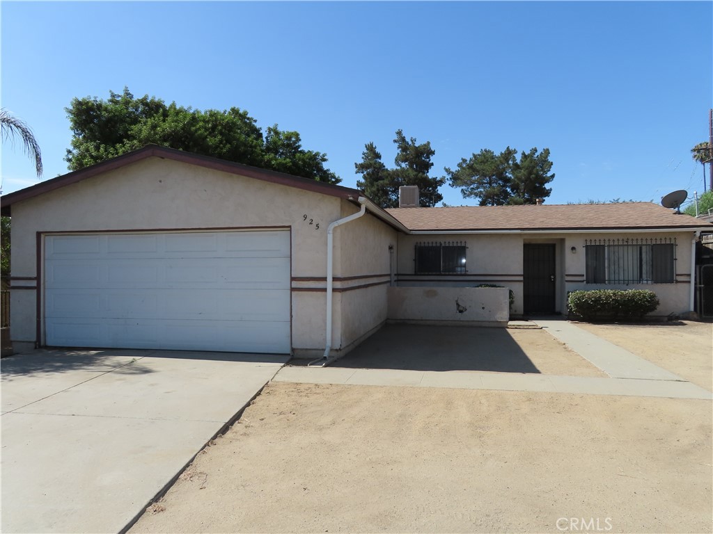 925 Navajo Road Perris, CA 92570 - Photo 4 of 15 a front view of a house with a garage
