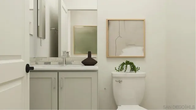 a bathroom with a sink toilet and mirror