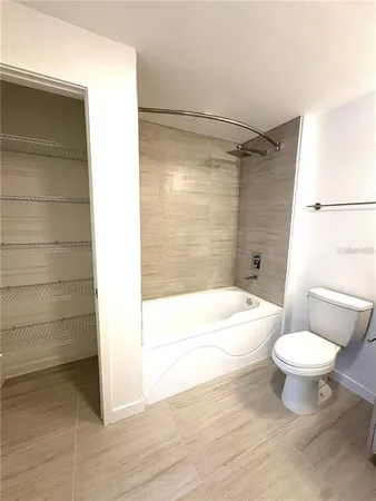a bathroom with a toilet a sink and bathtub