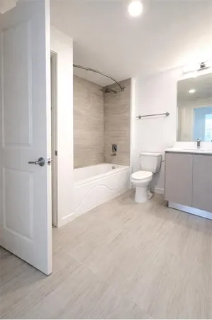a bathroom with a toilet and shower