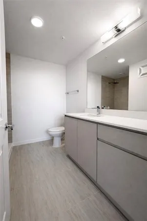 a bathroom with a double vanity sink and a toilet
