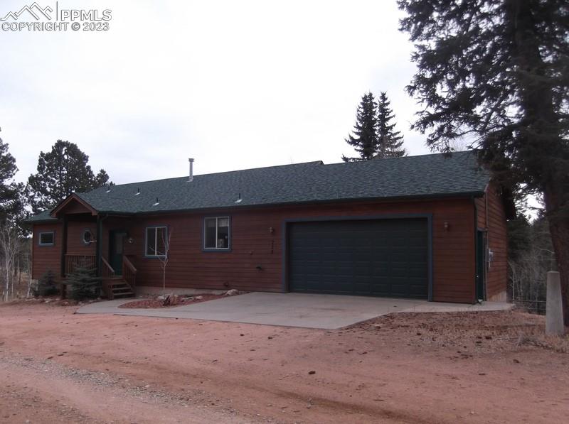 238 Aspen Circle Divide, CO 80814 - Photo 2 of 42 a front view of a house with a yard and garage