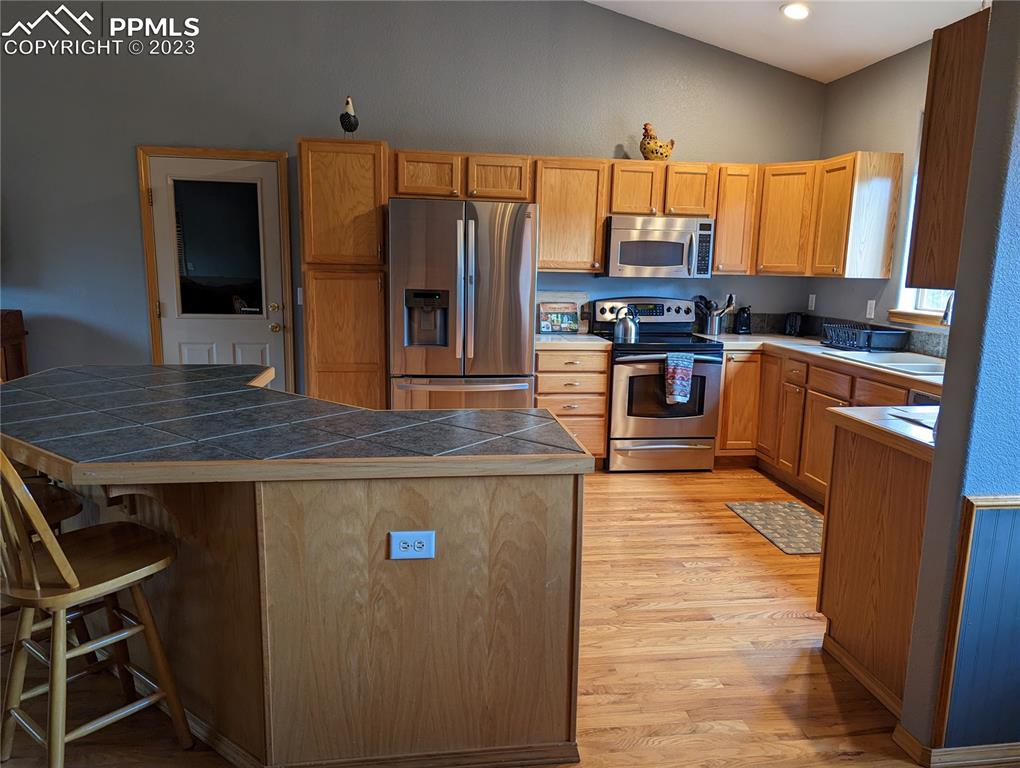 238 Aspen Circle Divide, CO 80814 - Photo 23 of 42 a kitchen with stainless steel appliances granite countertop a refrigerator a stove top oven and a sink