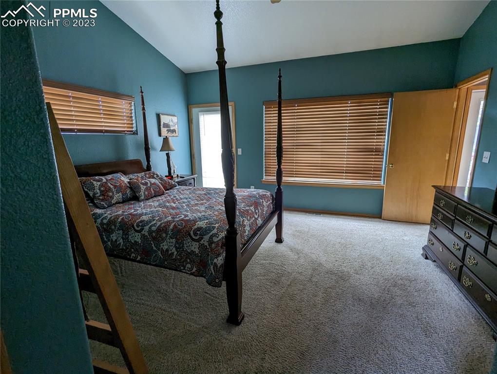 238 Aspen Circle Divide, CO 80814 - Photo 28 of 42 a bedroom with a bed flat screen tv and a large window