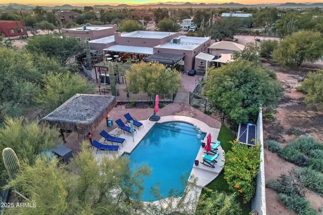an aerial view of a house with garden space and street view