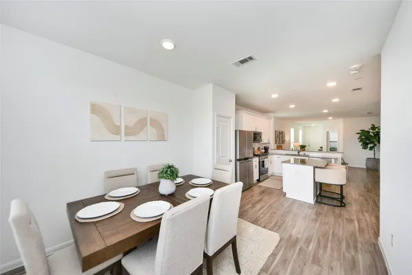 a view of a dining room with furniture and wooden floor