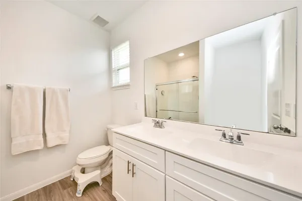 a bathroom with a sink a toilet and a mirror