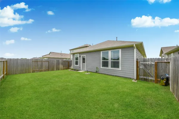 a view of a house with a backyard