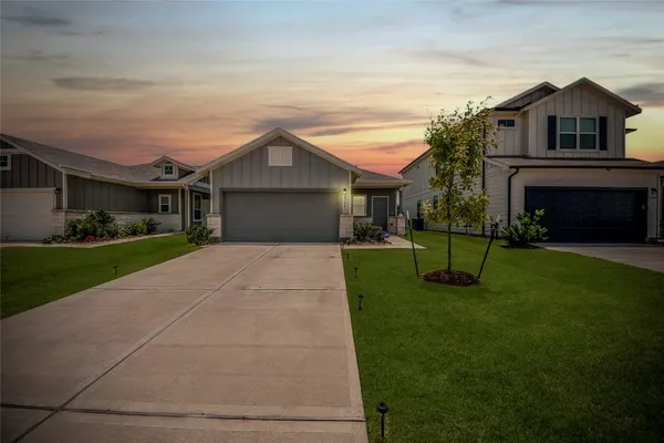 a front view of house with yard and green space