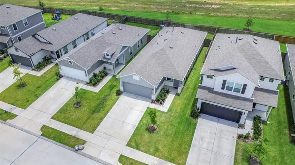 an aerial view of a house with garden space and street view