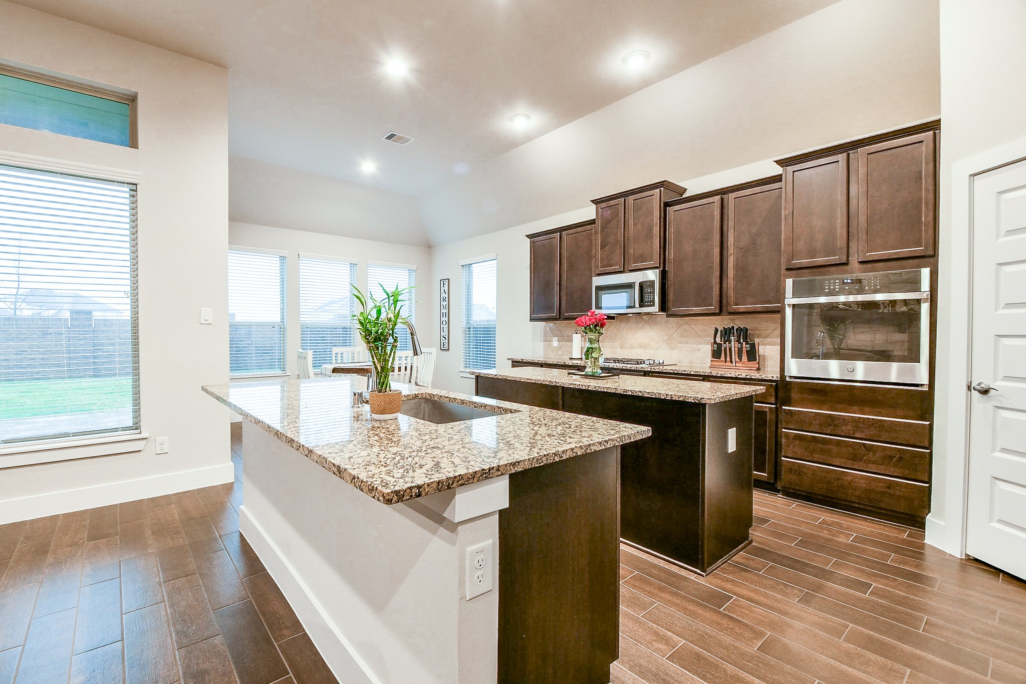 236 Bright Bluff Circle Waller, TX 77484 - Photo 11 of 32 a kitchen with stainless steel appliances granite countertop a sink stove and refrigerator
