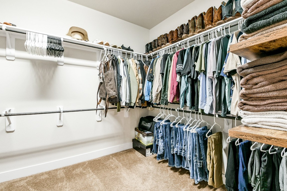 236 Bright Bluff Circle Waller, TX 77484 - Photo 24 of 32 a view of walk in closet with clothes and shoes