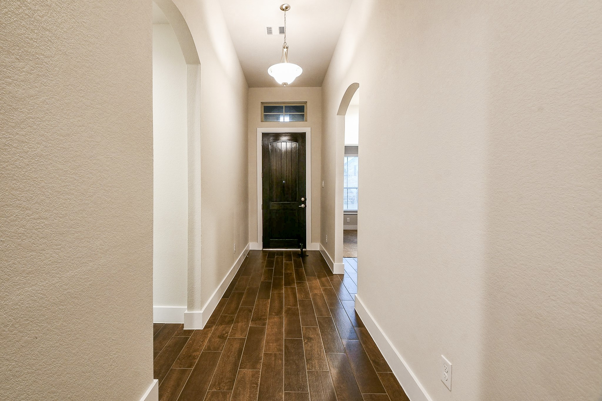 236 Bright Bluff Circle Waller, TX 77484 - Photo 3 of 32 a view of a hallway with wooden floor and staircase