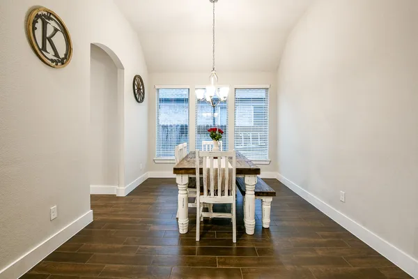 a view of a dining room with furniture wooden floor and chandelier
