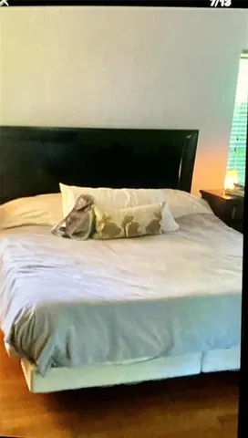 a bedroom with a bed and window