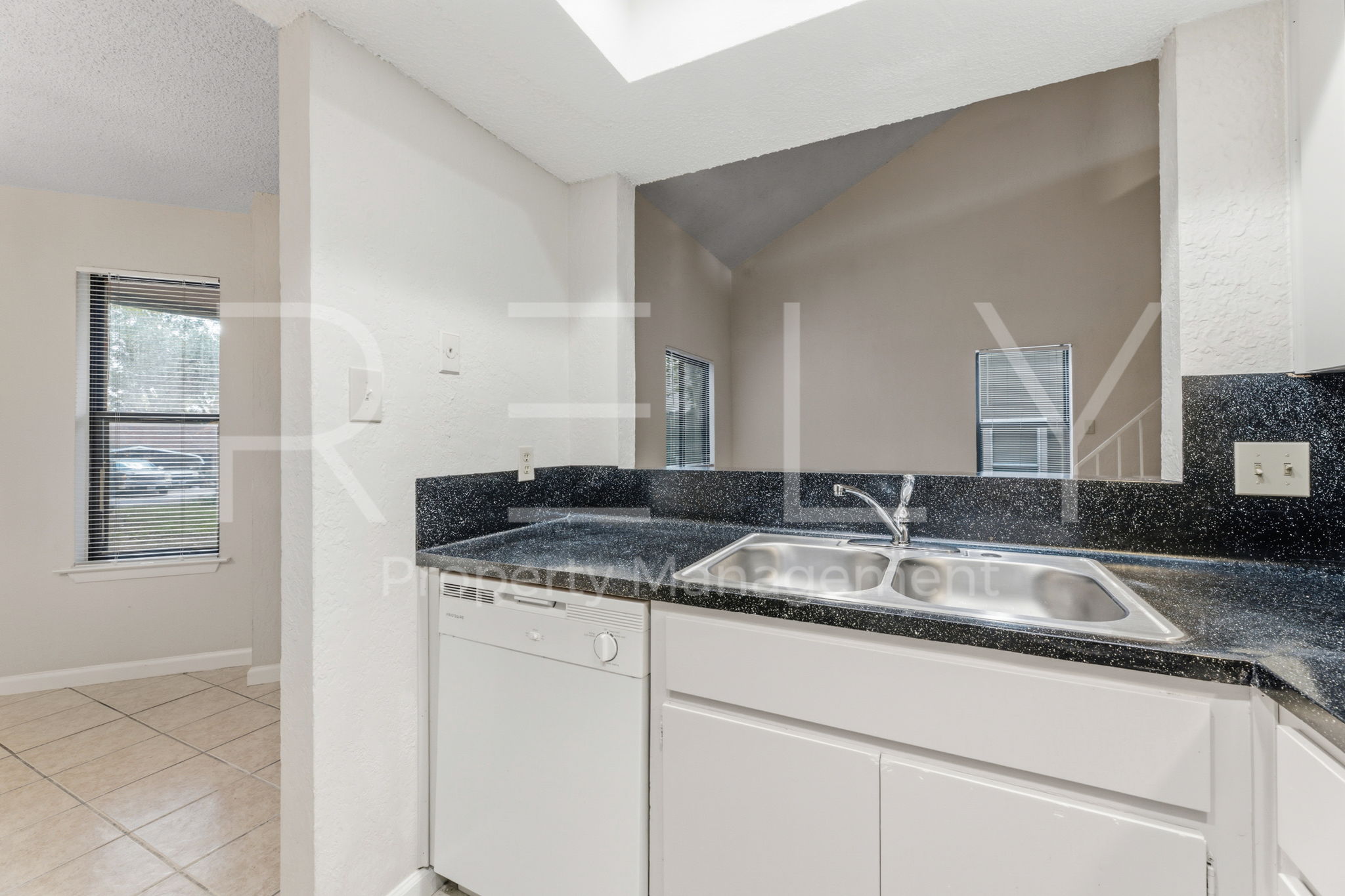 1005 Milford Way, Unit A Austin, TX 78745 - Photo 16 of 30 a bathroom with a granite countertop sink and a mirror