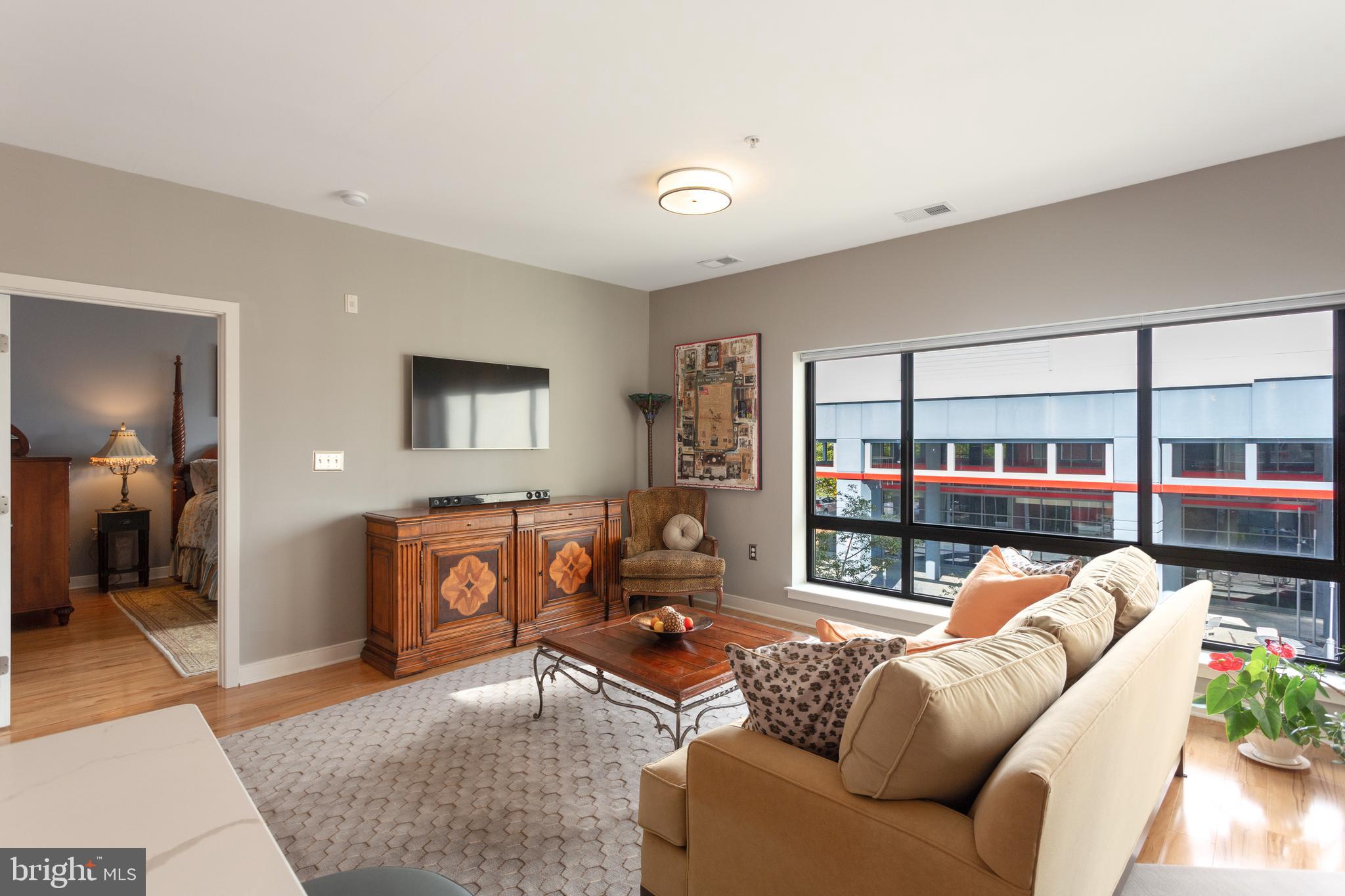 8005 13th Street, Unit 305 Silver Spring, MD 20910 - Photo 27 of 40 a living room with furniture and a large window