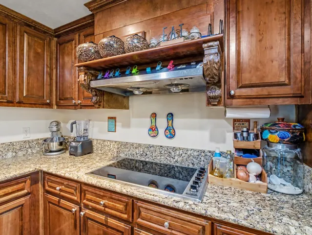 a kitchen with lots of counter top space and wooden floor