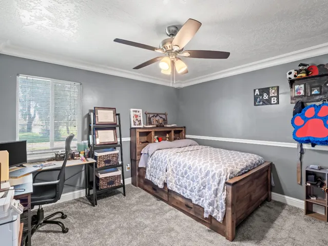a bedroom with a bed and a chandelier