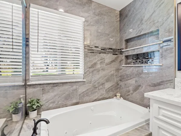 a bathroom with a bathtub and a shower