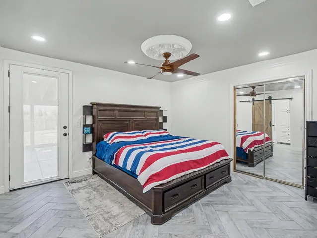 a spacious bedroom with a bed and a chandelier