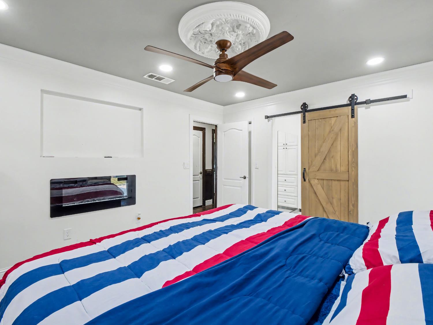 16998 Rio Plaza Road Madera, CA 93636 - Photo 21 of 42 a bedroom with a bed and a chandelier