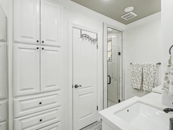 a bathroom with a shower a sink and a mirror