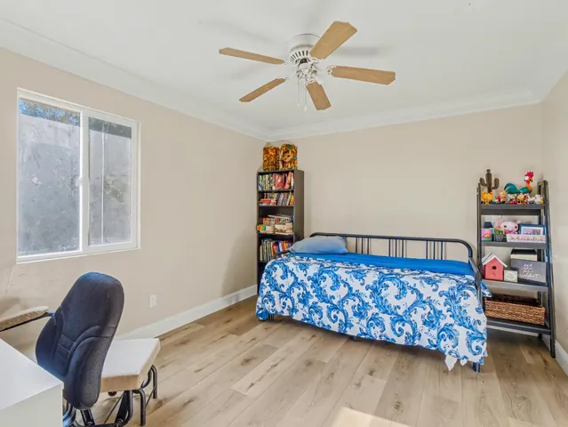a bedroom with a bed and a book shelf