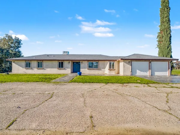 a view of an house with backyard space and balcony