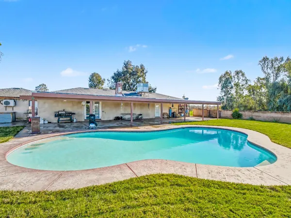 a view of a swimming pool with a lawn chairs