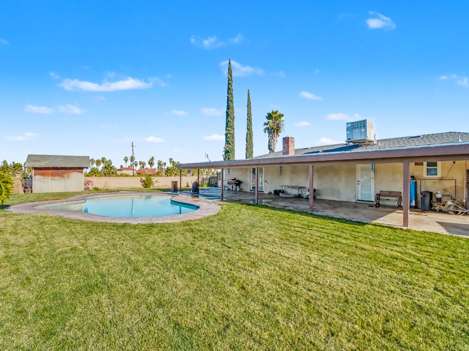 16998 Rio Plaza Road Madera, CA 93636 - Photo 41 of 42 a view of a swimming pool with lawn chairs