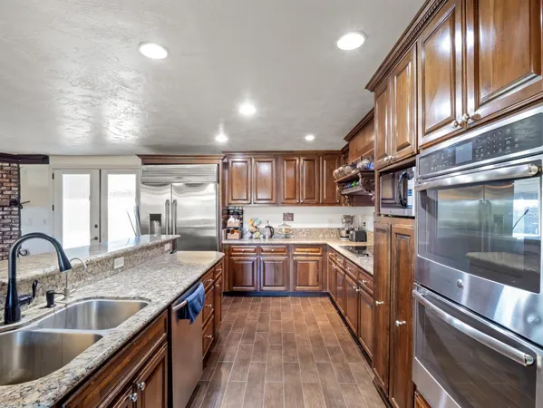 a kitchen with stove a sink and refrigerator