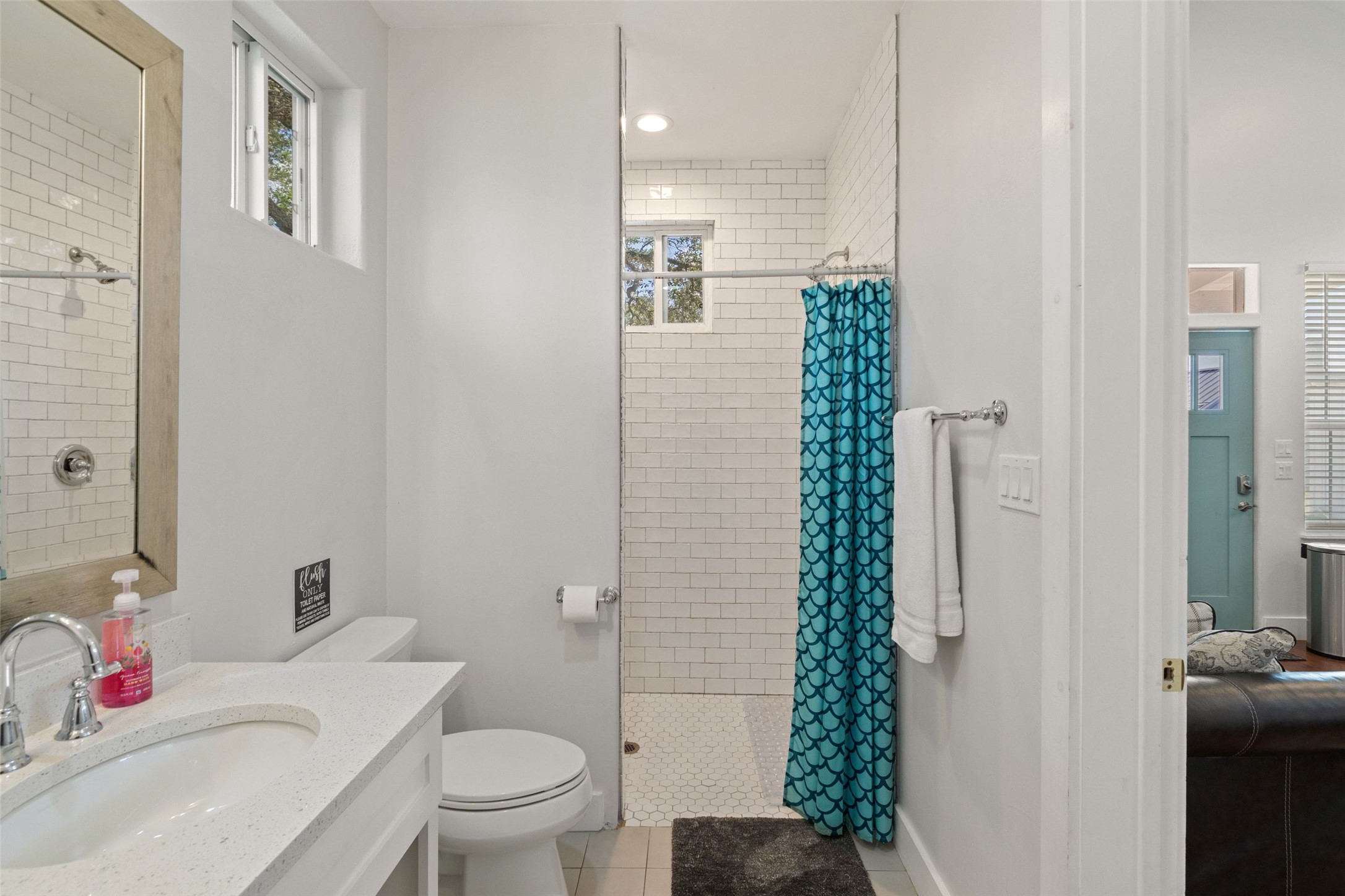 810 Kothmann Road Dripping Springs, TX 78620 - Photo 29 of 40 Subway tile surrounds the walk-in shower in this modern bathroom featuring stone counters.