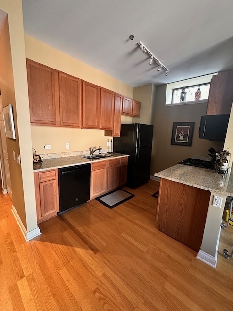 8 West Monroe Street, Unit 1410 Chicago, IL 60603 - Photo 8 of 16 a kitchen with stainless steel appliances granite countertop a refrigerator a stove top oven a sink and dishwasher