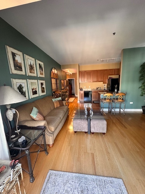 8 West Monroe Street, Unit 1410 Chicago, IL 60603 - Photo 9 of 16 a living room with furniture and a wooden floor