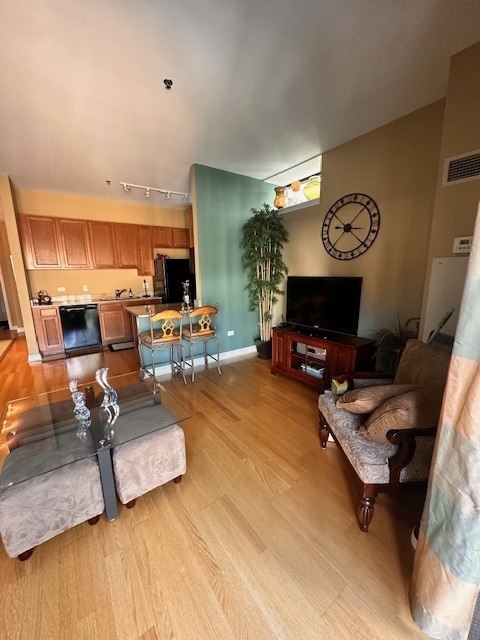 8 West Monroe Street, Unit 1410 Chicago, IL 60603 - Photo 10 of 16 a living room with furniture and a flat screen tv