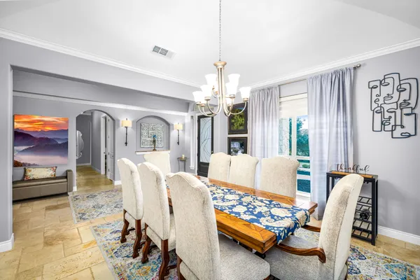a living room with furniture and a chandelier